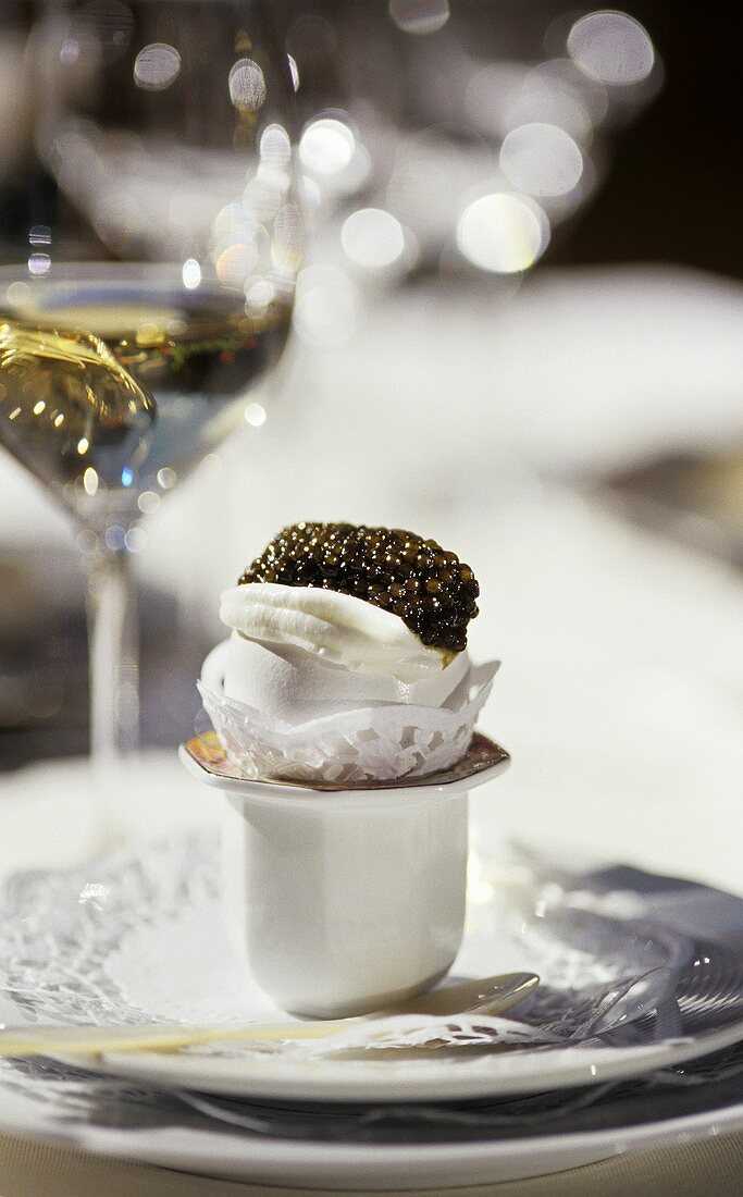 An egg with caviar served in an egg cup