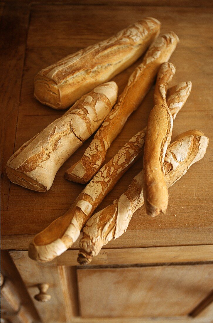 Various light baguettes on top of a cupboard