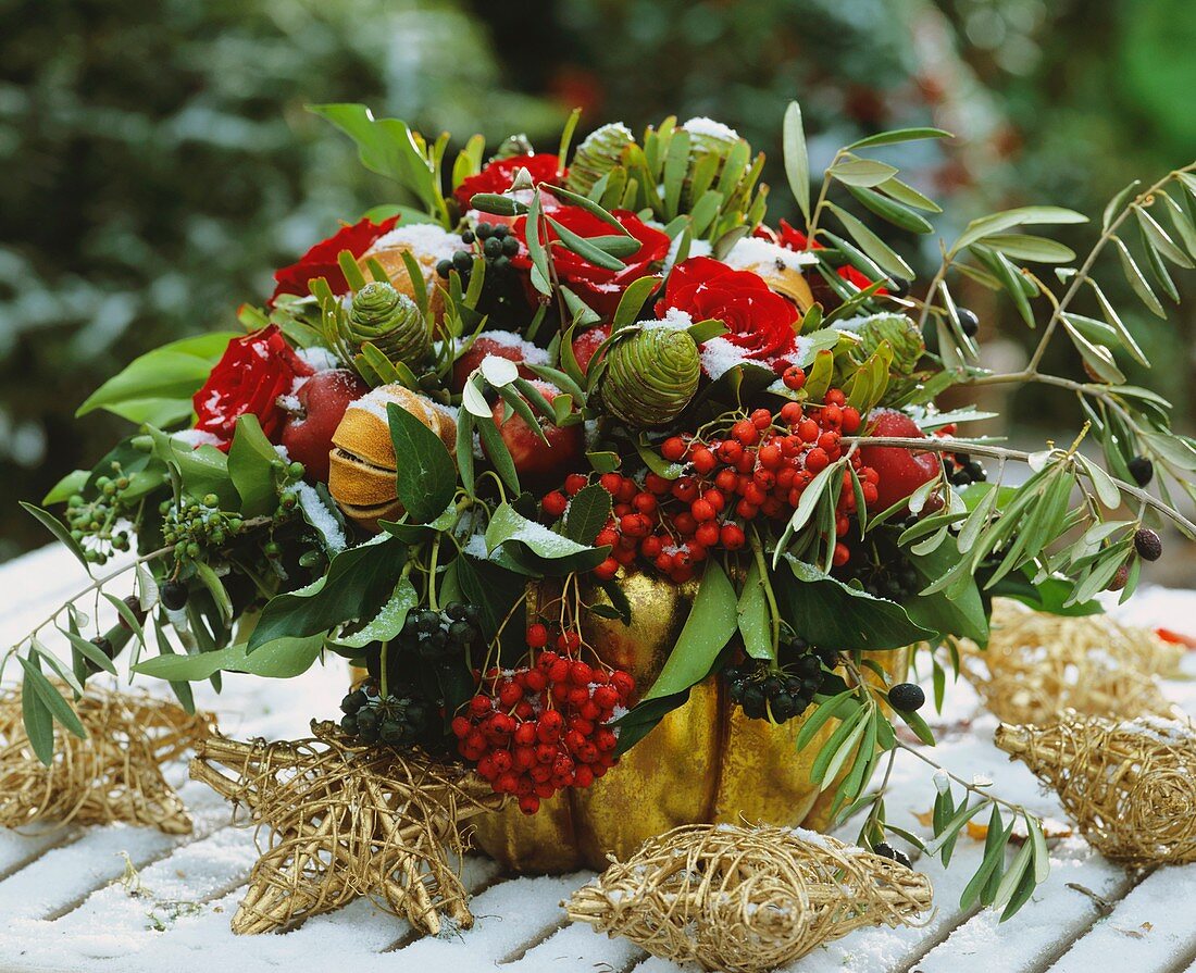 A winter bouquet of roses, ivy, rowan and ornamental apples