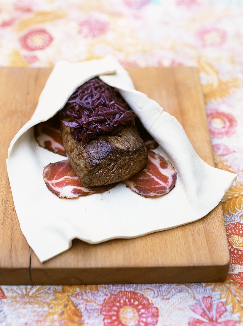 Preparing beef fillet wrapped in puff pasty