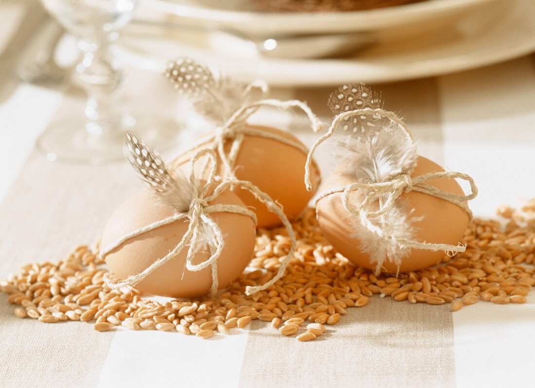 Easter decoration: grains of corn and eggs with feathers