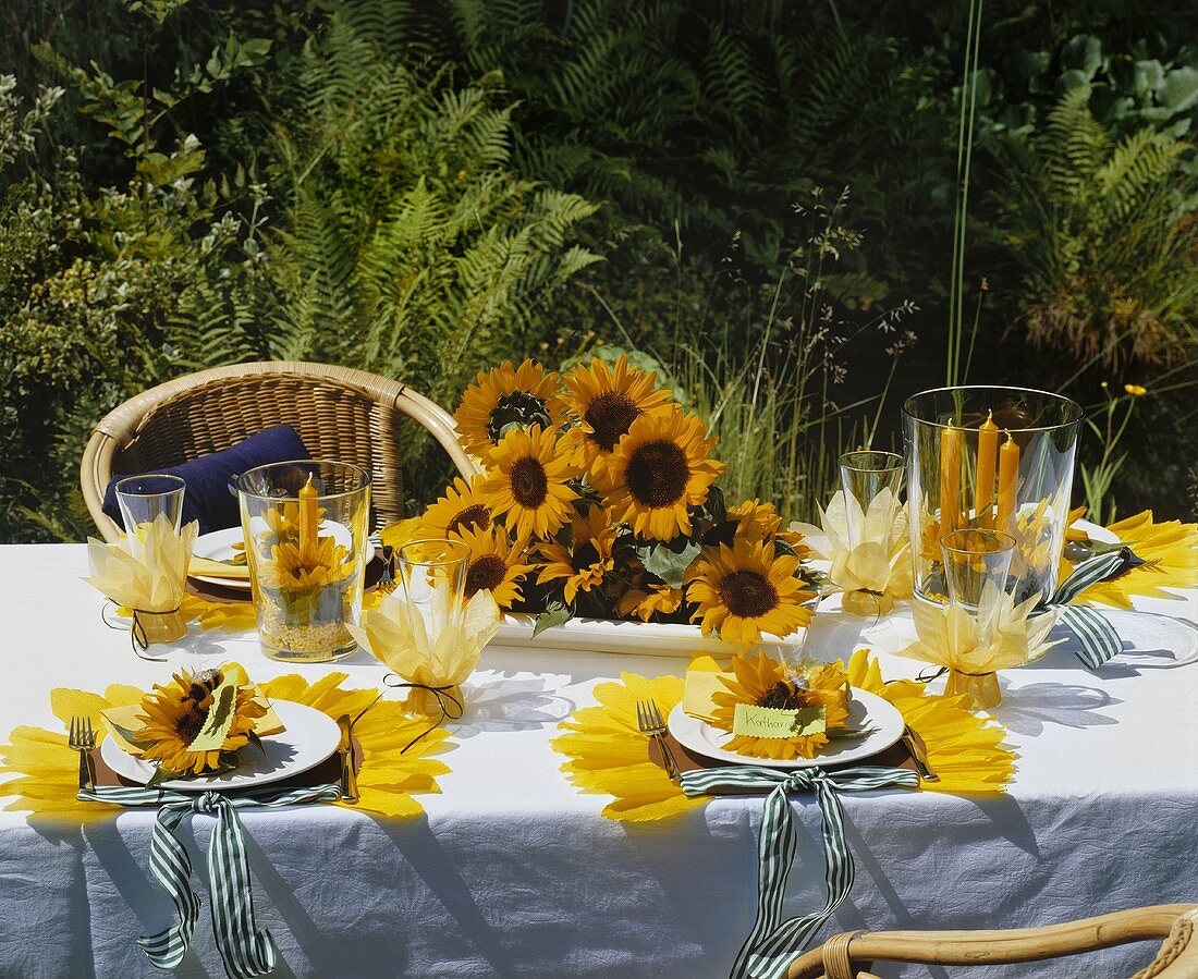 A festively laid table decorated with sunflowers in the garden