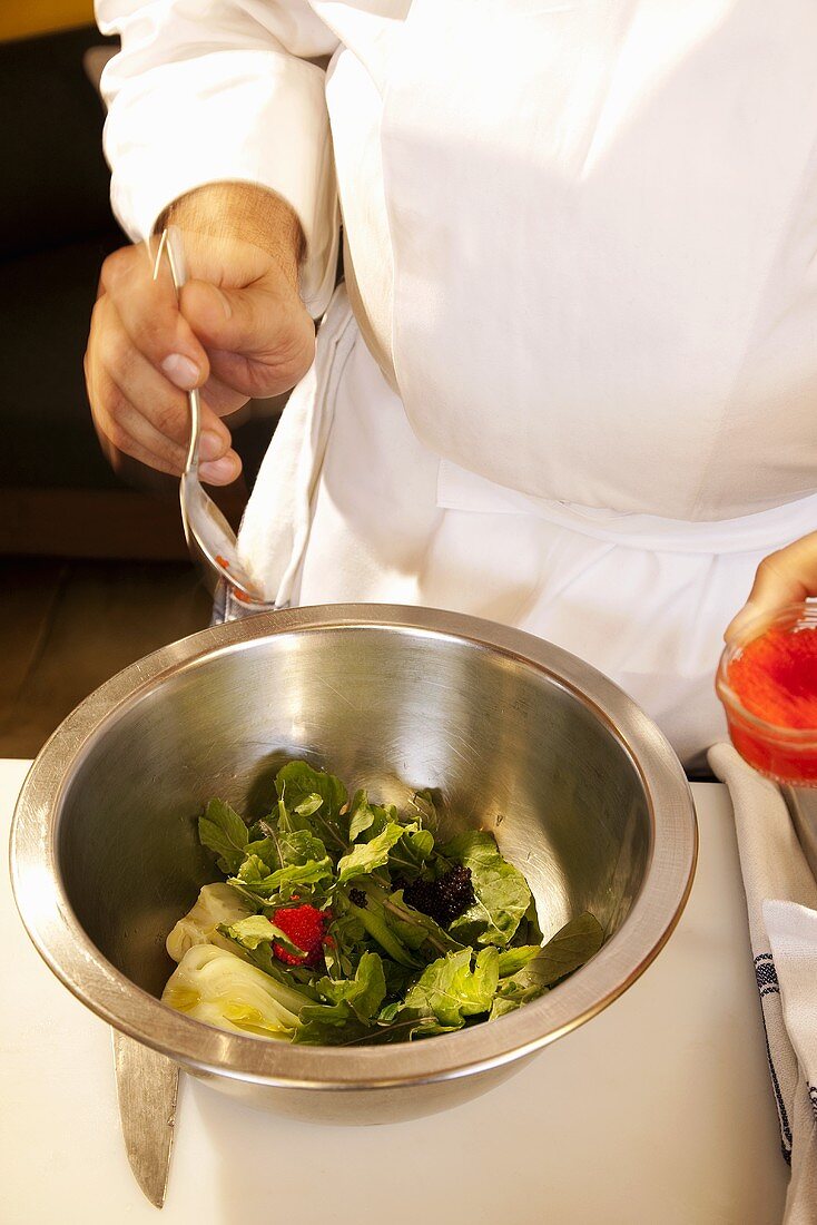 Lettuce leaves and bok choy in a bowl with caviar