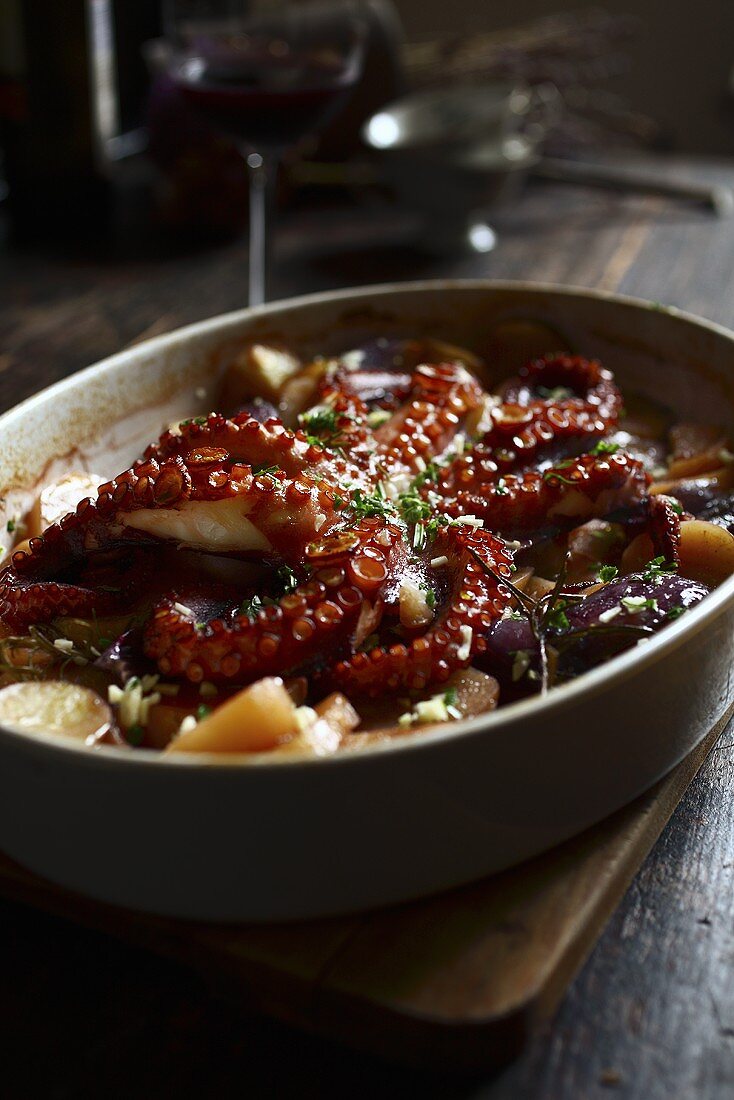 Oven-baked octopus with potatoes and onions