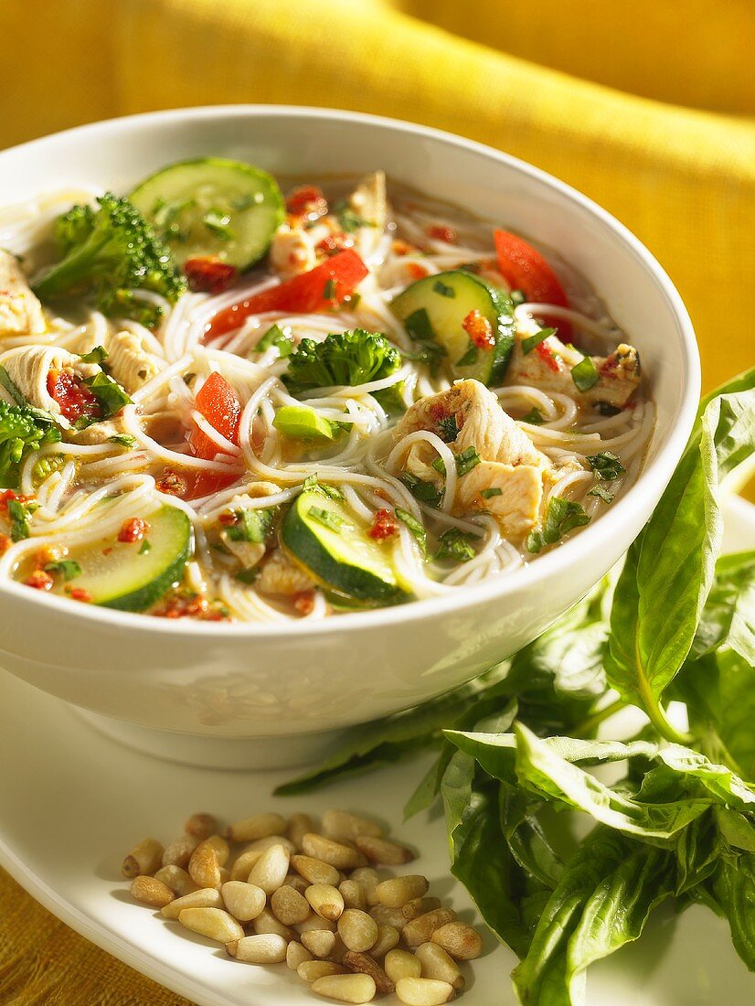 Chicken soup with noodles, vegetables and pesto