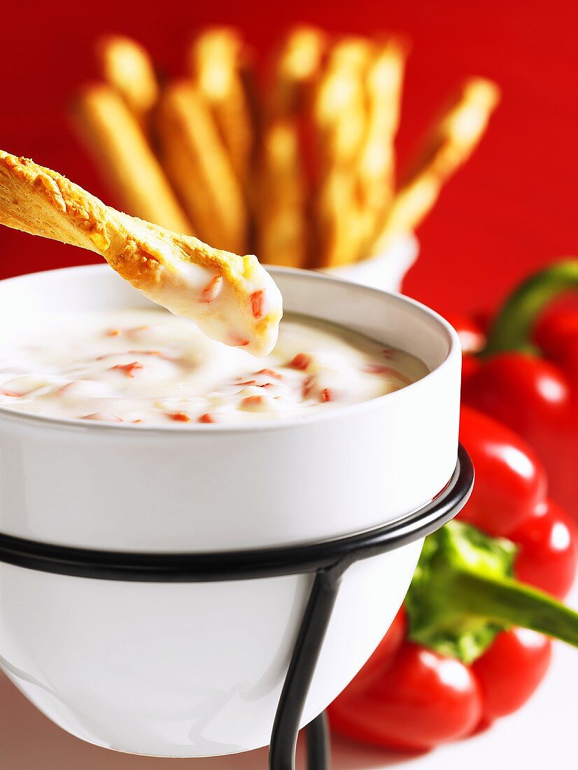 Mozzarella fondue with cheese sticks and peppers