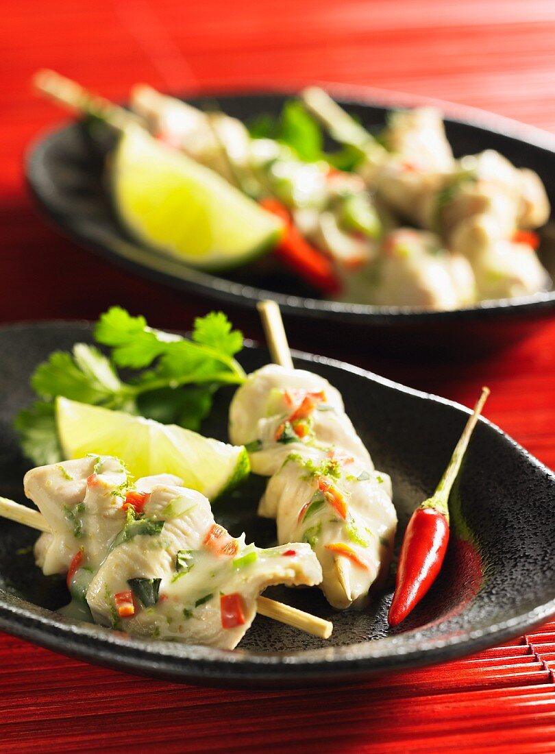 Spicy chicken fondue with chilli peppers and limes