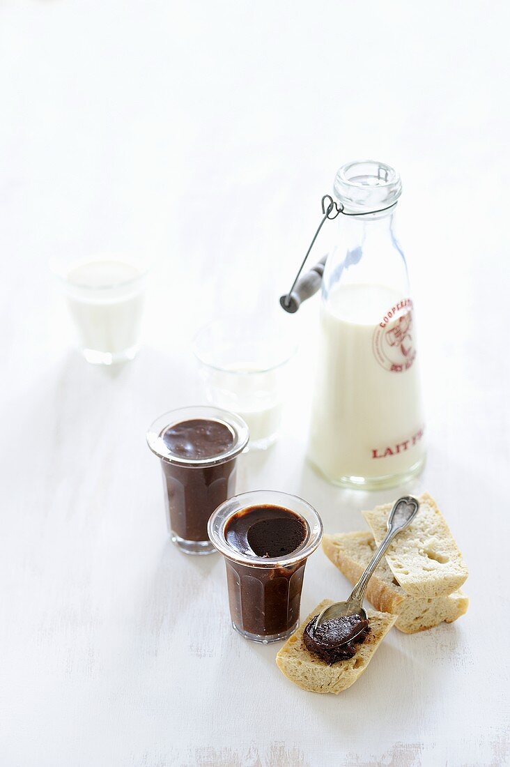 Slices of baguette with chocolate spread and milk