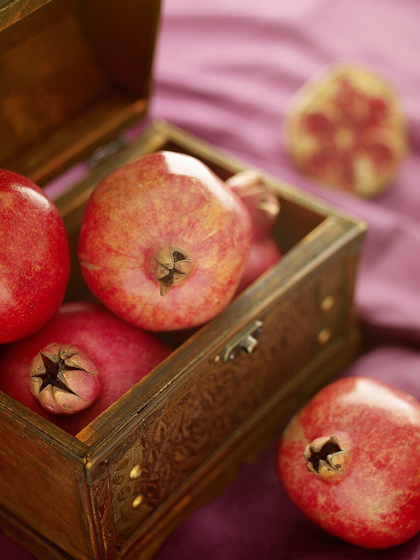 Pomegranates in a wooden crate