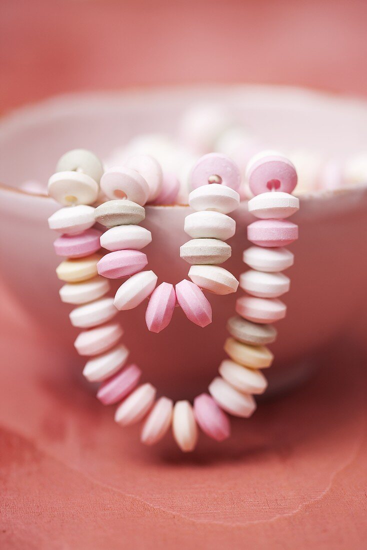 A candy necklace in a bowl