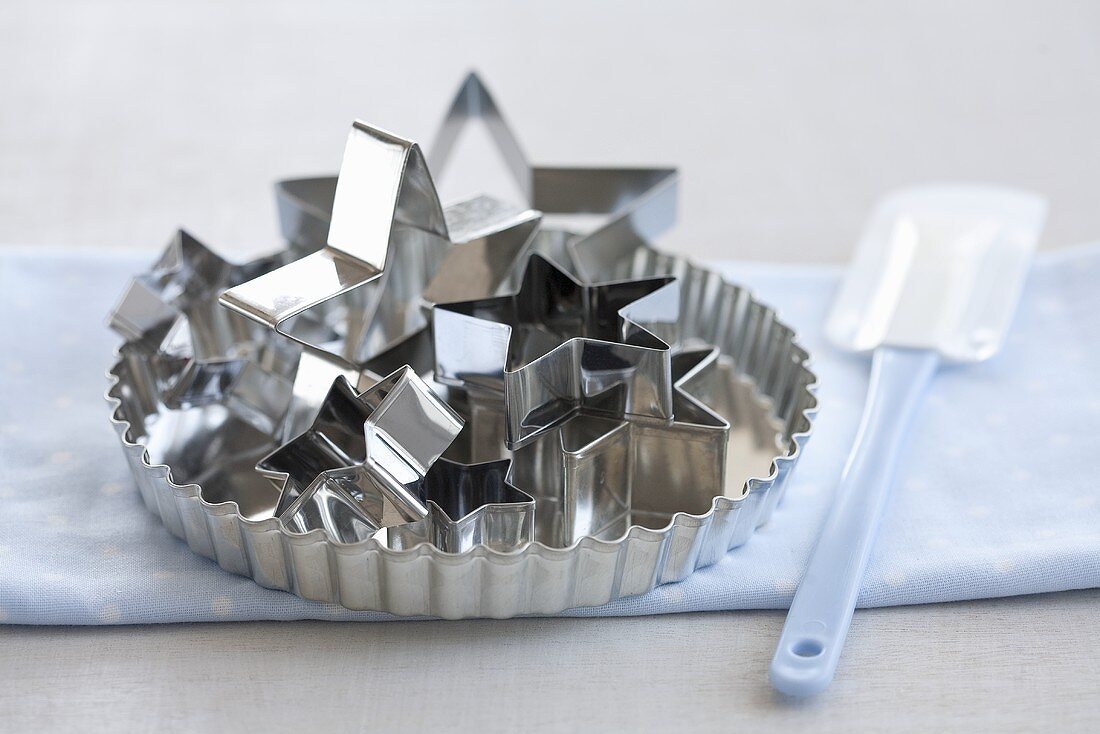 A tart dish, star-shaped cutters and a spatula