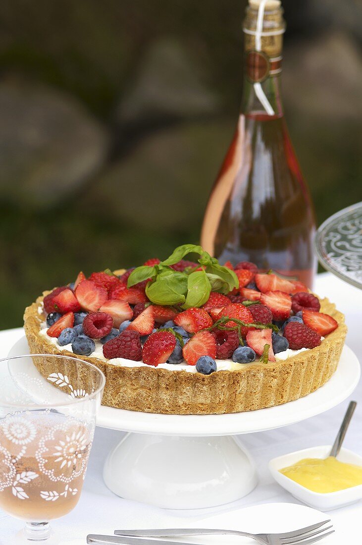 A berry tart on a table outside