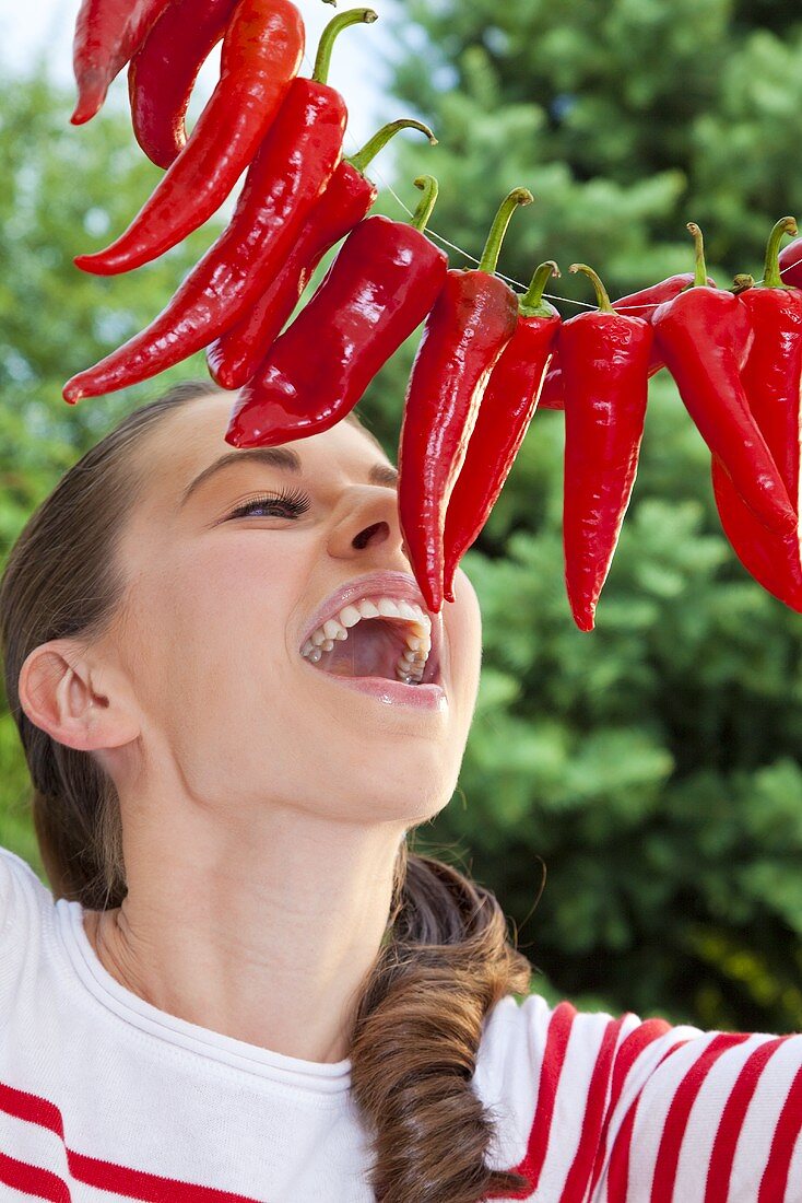 A girl with chillis on a string