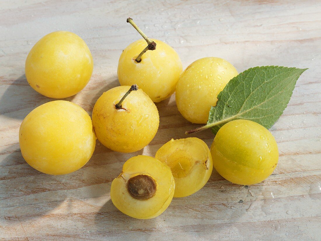 Fresh mirabelles, whole and halved