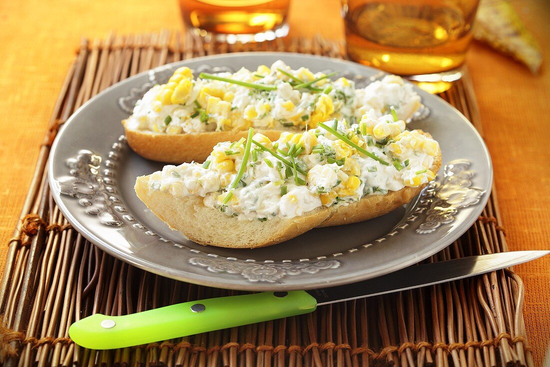 Baguette topped with cream cheese and sweetcorn