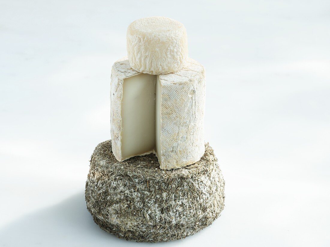 A stack of three types of goats' cheese