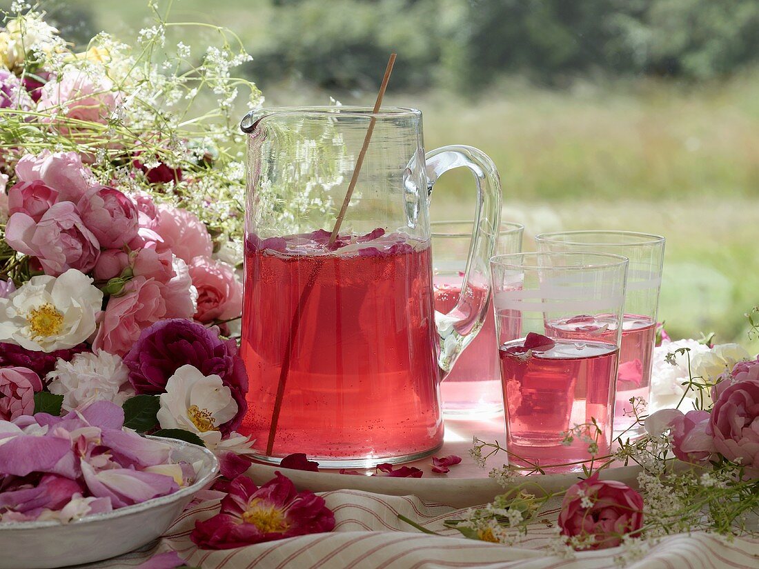 A jug of rose petal punch and rose decorations