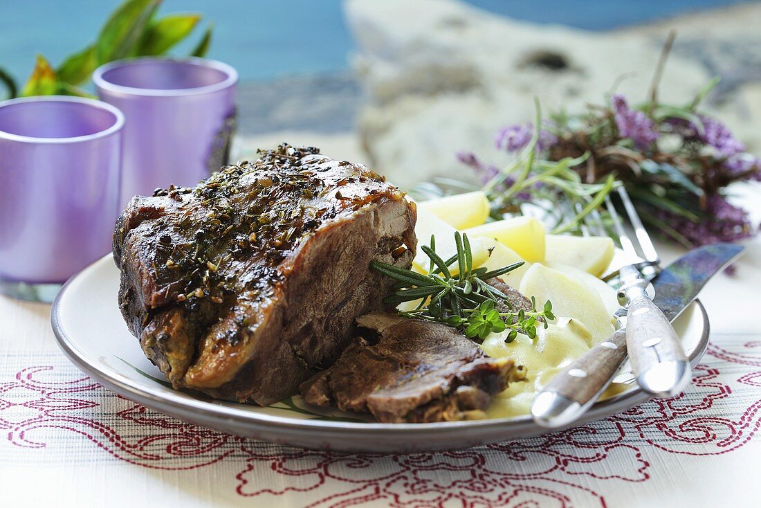 A leg of lamb with salted potatoes