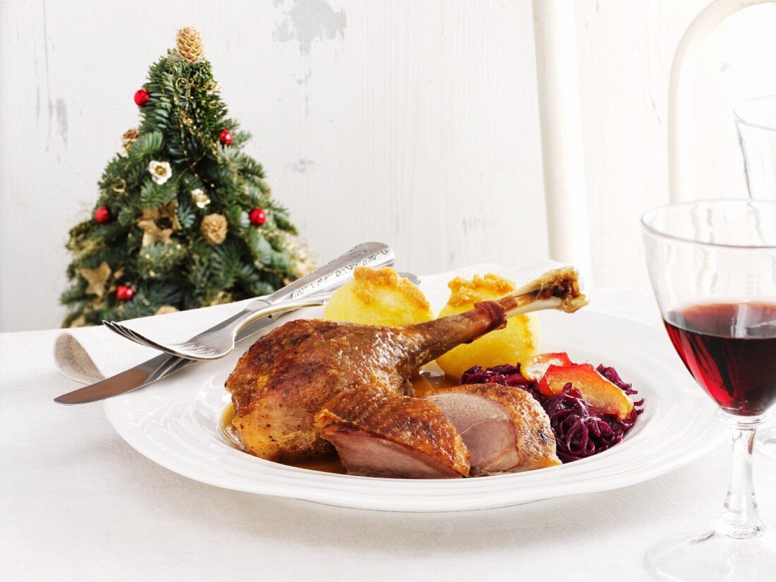Roast goose with red cabbage and potato dumplings for Christmas dinner