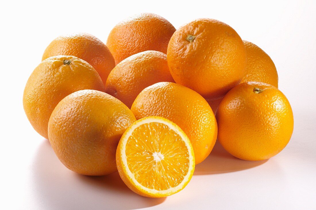 Several oranges and an orange half