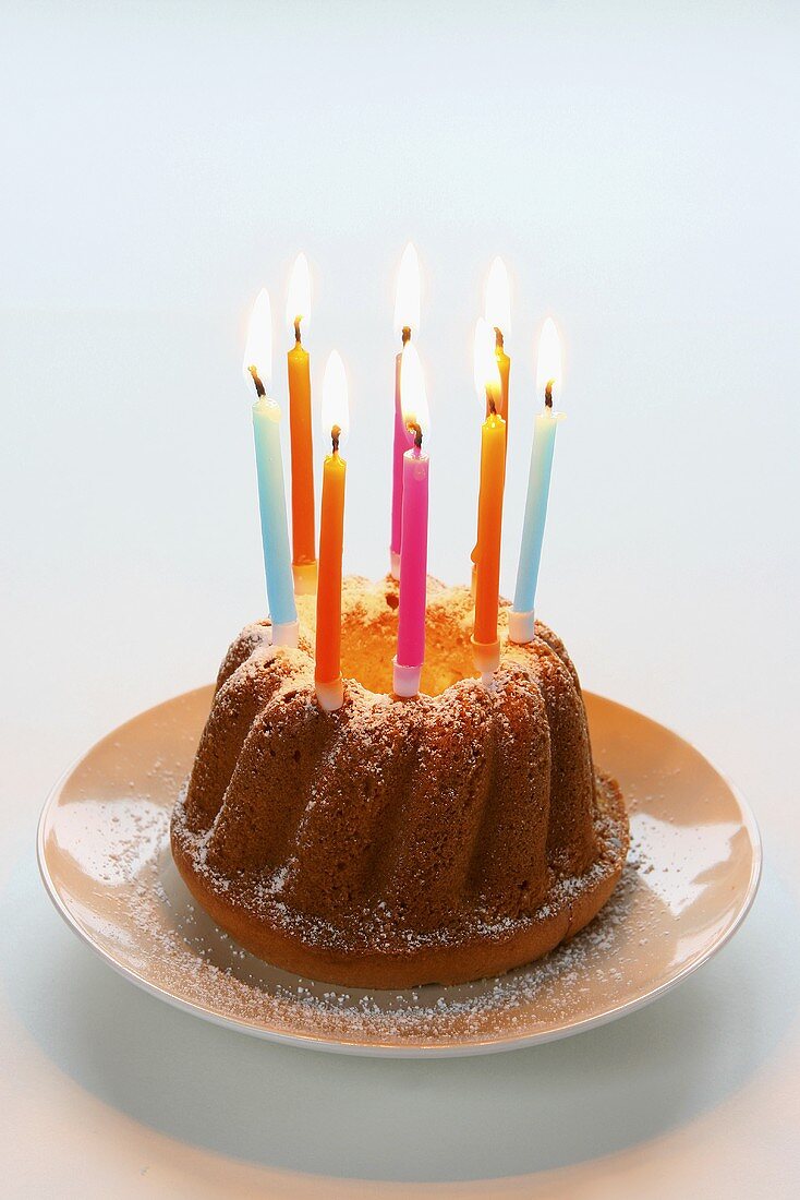 Bundt cake with colourful candles