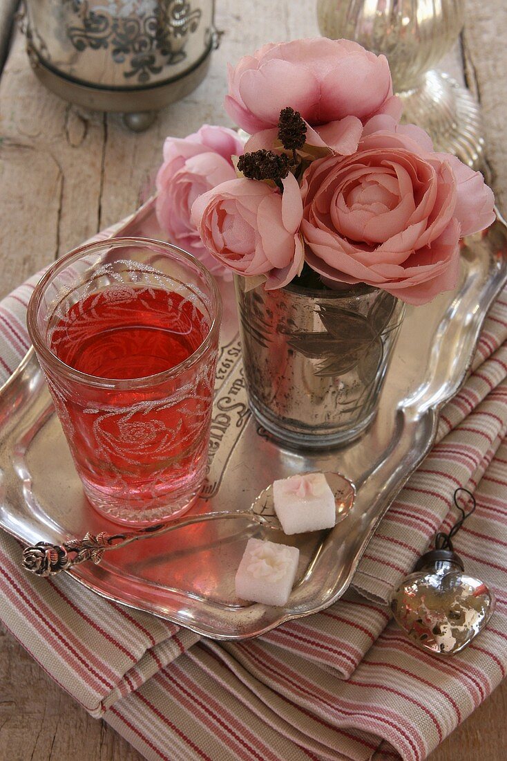 Fruit tea and a bouquet of faux roses