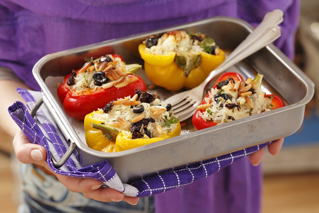 Gefüllte Paprika mit Reis, getrockneten Tomaten, Oliven, Pinienkernen und Feta