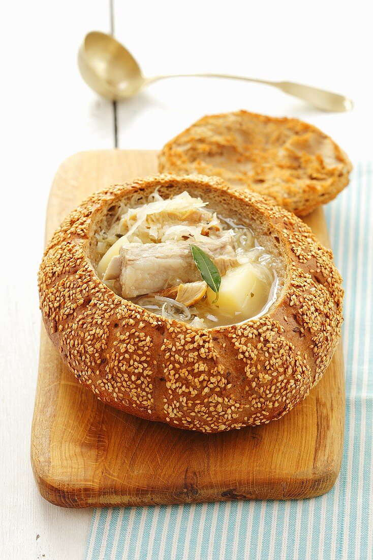 Sauerkraut soup with pork ribs served in hollowed out bread