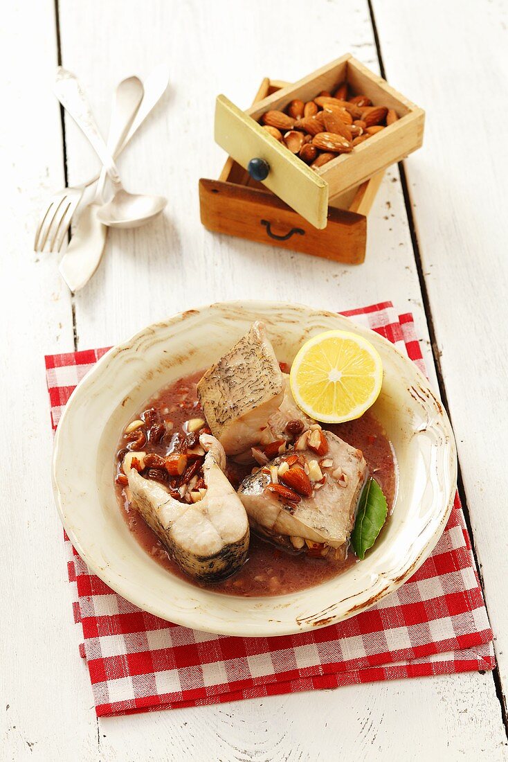 Hake with almonds and raisins in red wine sauce (Poland)