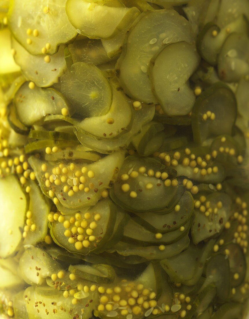 Pickled gherkins in a jar (close-up)