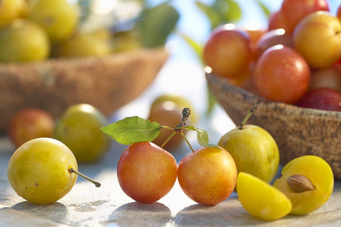 Mirabelles in and in front of wooden bowls