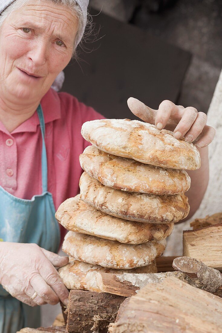 Countrywoman holding freshly baked (from wood-fired oven)