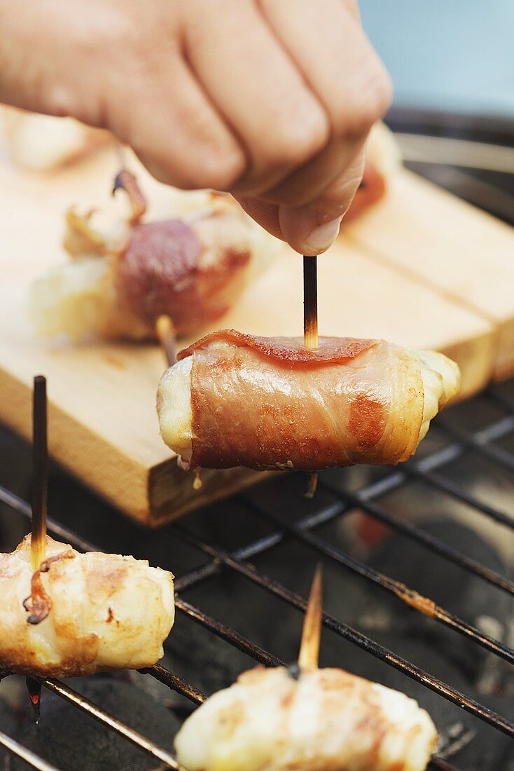 Chicken and bacon kebabs on barbecue