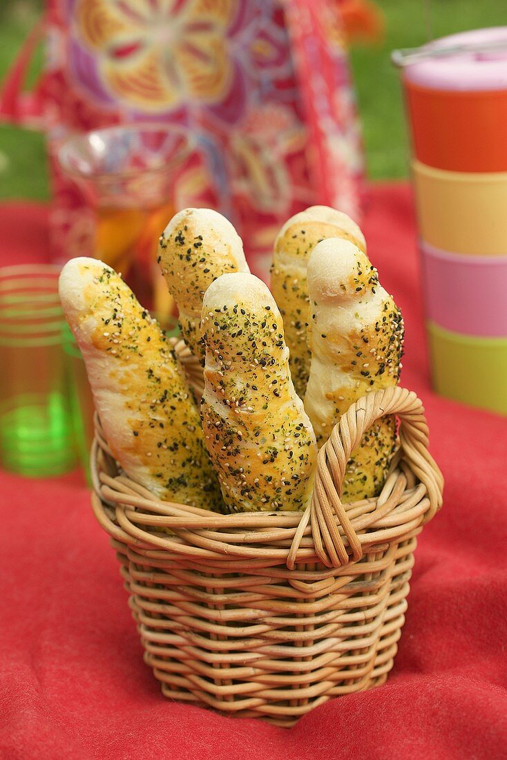 Herb and sesame baguettes in a basket