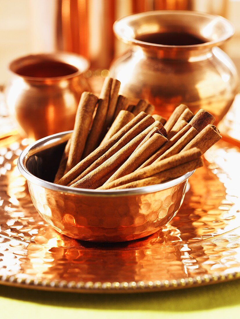 Cinnamon sticks in copper bowl