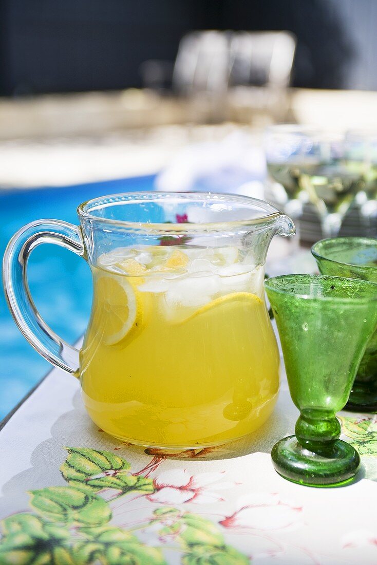 Lemonade in a jug by a pool