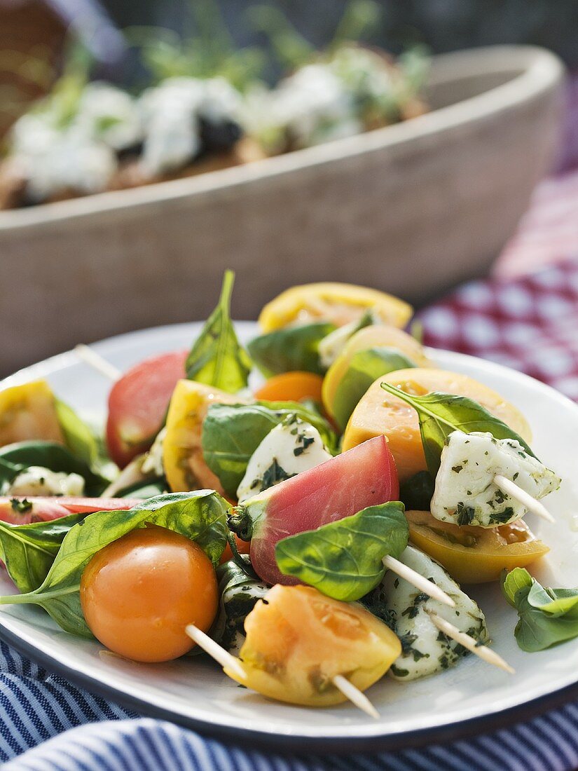 Mozzarella and tomato skewers with basil