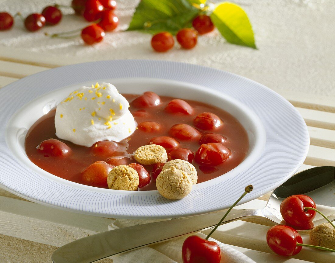 Cold sour cherry soup with whipped cream and amarettini