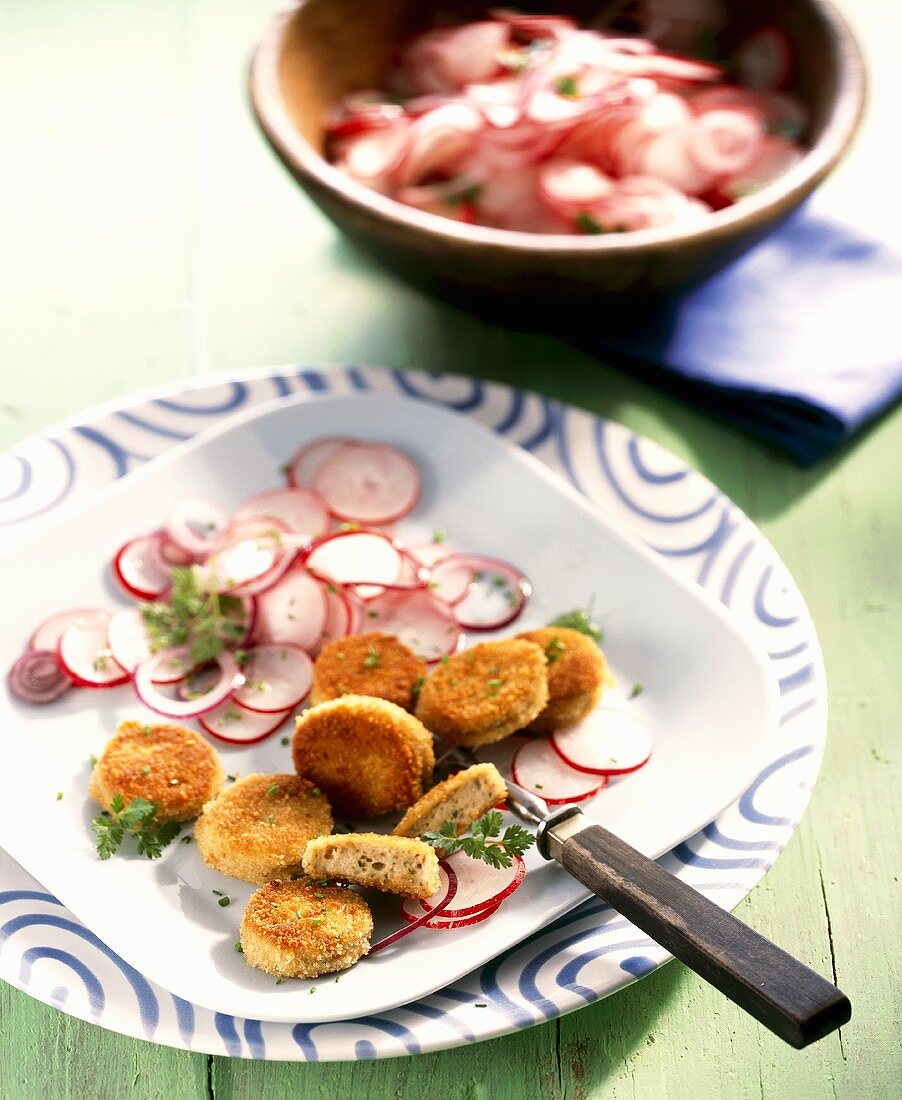 Breaded, fried slices of white sausage with radish salad