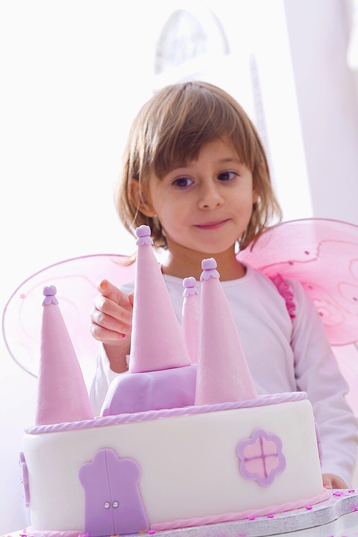 Girl dressed as fairy with marzipan cake