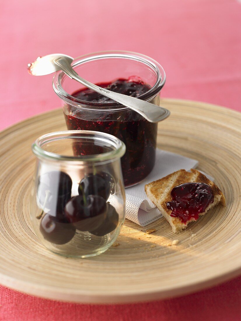 Cherry and coconut jam in jar and on toast