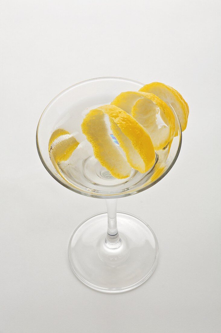 A glass of Martini with lemon peel