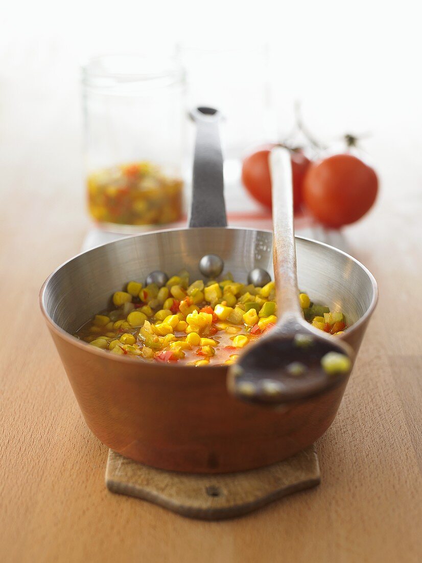 Home-made corn relish in a copper pan