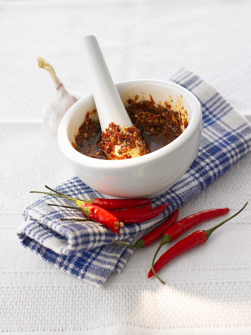 Harissa in mortar, red chillies