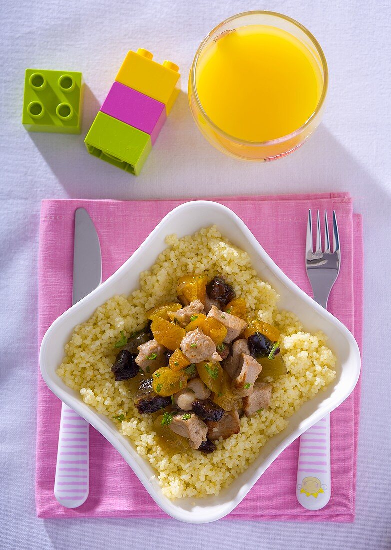 Pork with plums and apricots on couscous