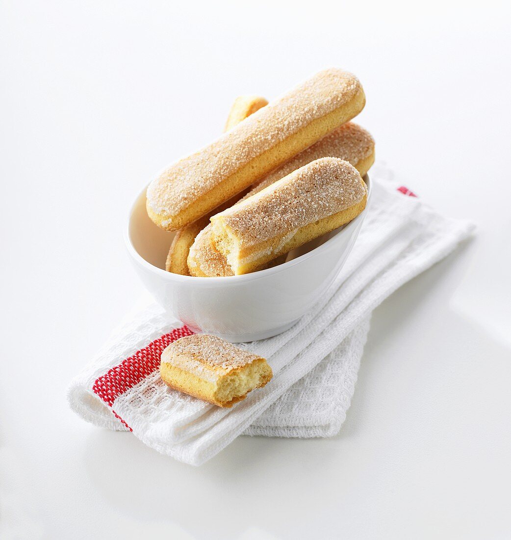 Sponge fingers in bowl on tea towel