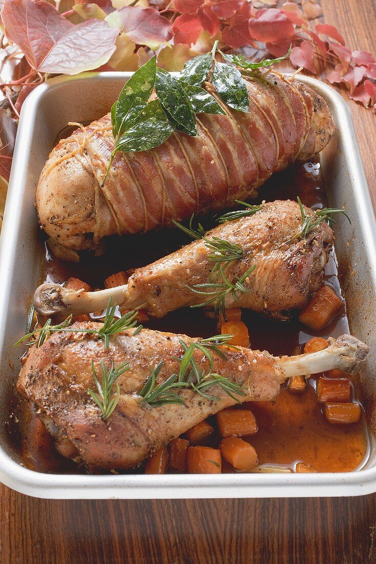Turkey legs & bacon-wrapped turkey breast in roasting tin