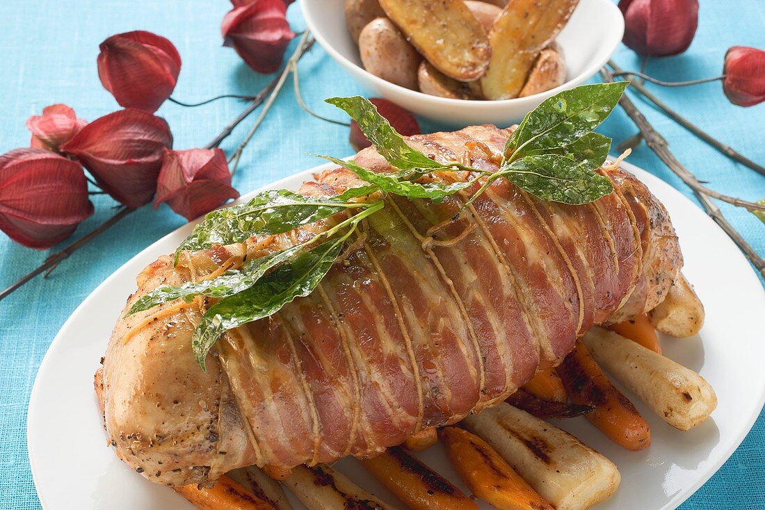Bacon-wrapped turkey breast on roasted root vegetables
