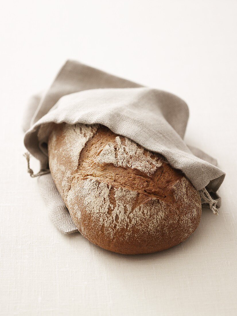 Brown bread (made with wheat and rye flour) in linen bag