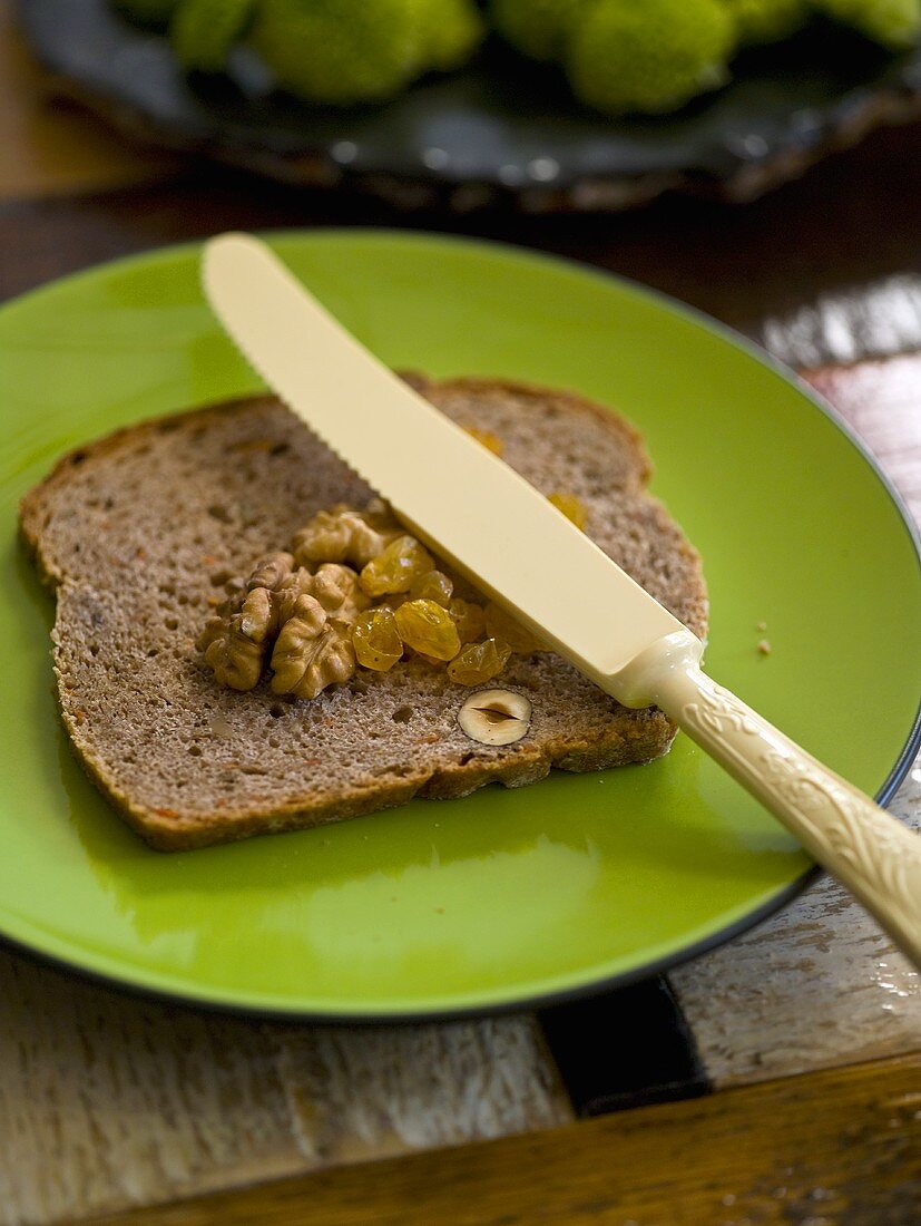 A slice of nut bread with walnuts and dried fruit